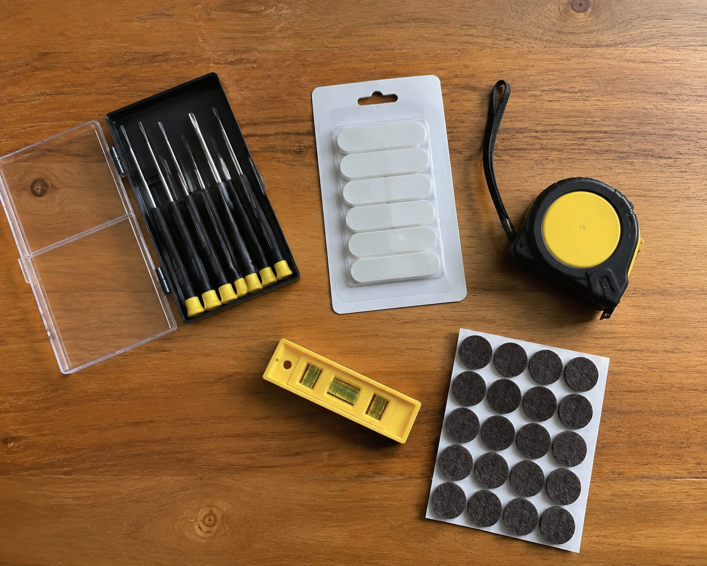 Top-down flat lay of a basic renter toolkit on a wooden table